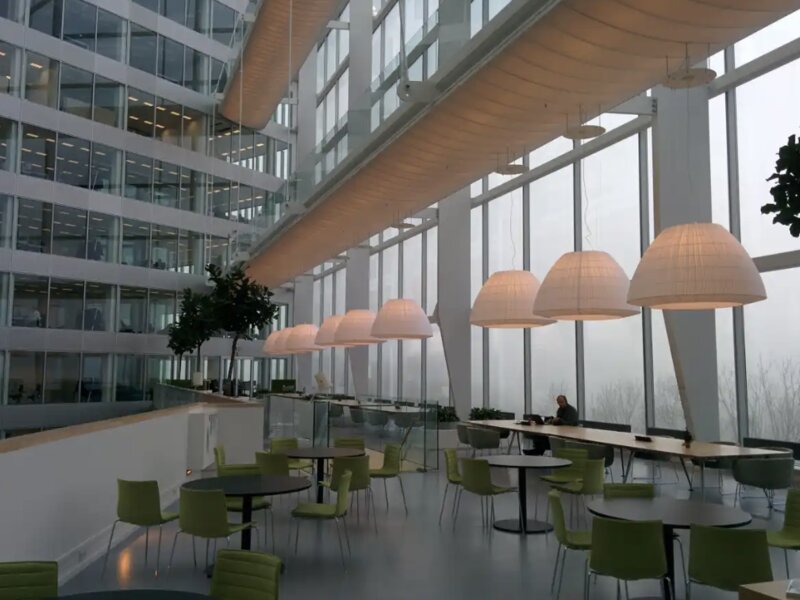 Open-plan office workstations next to enclosed private offices
