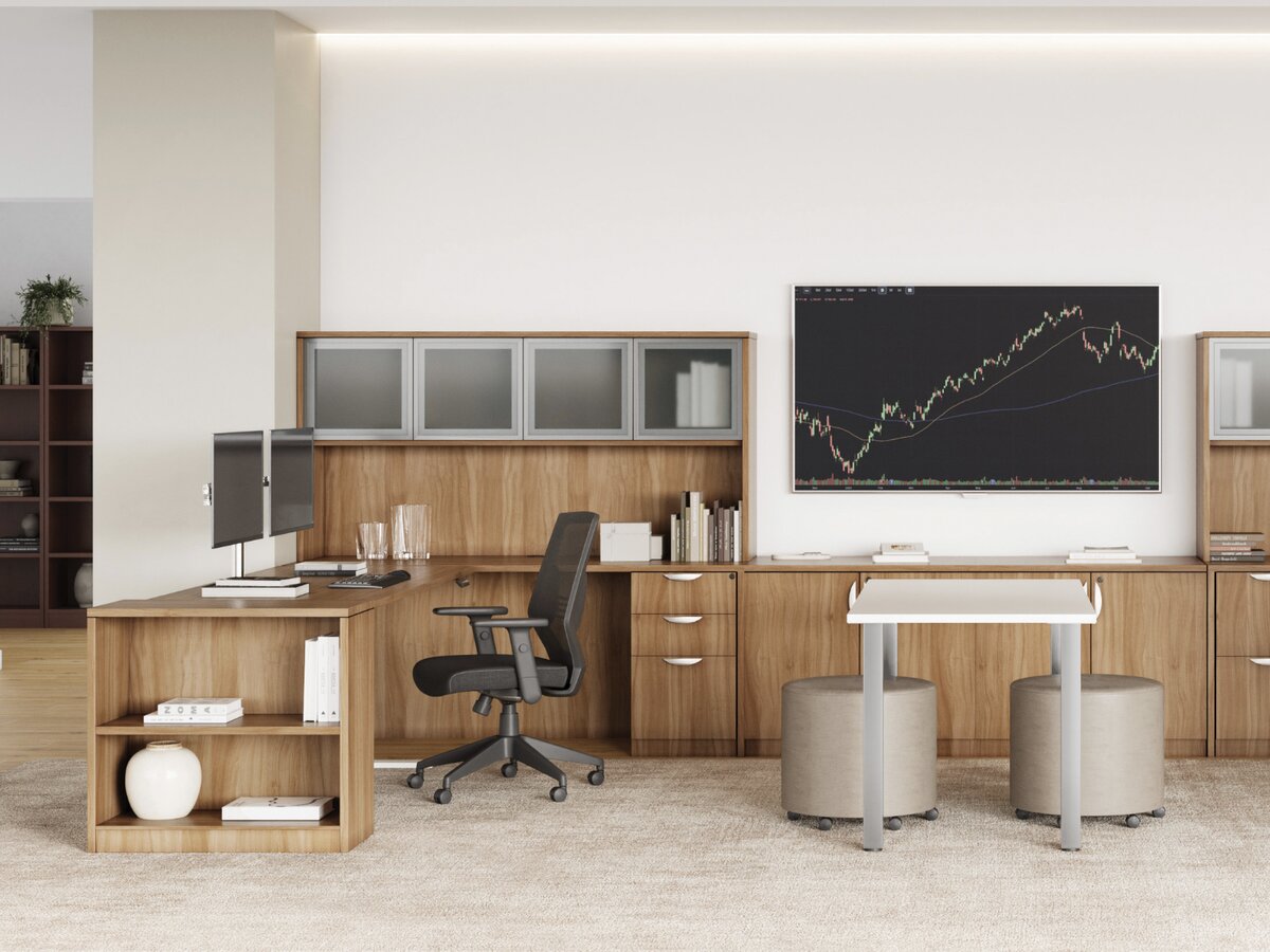 Office manager and a commercial furniture supplier reviewing desk and chair options in a showroom