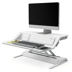 Lotus DX Sit-Stand Workstation (Dual Monitor Arm Extra) - Studio white background [AI office context]